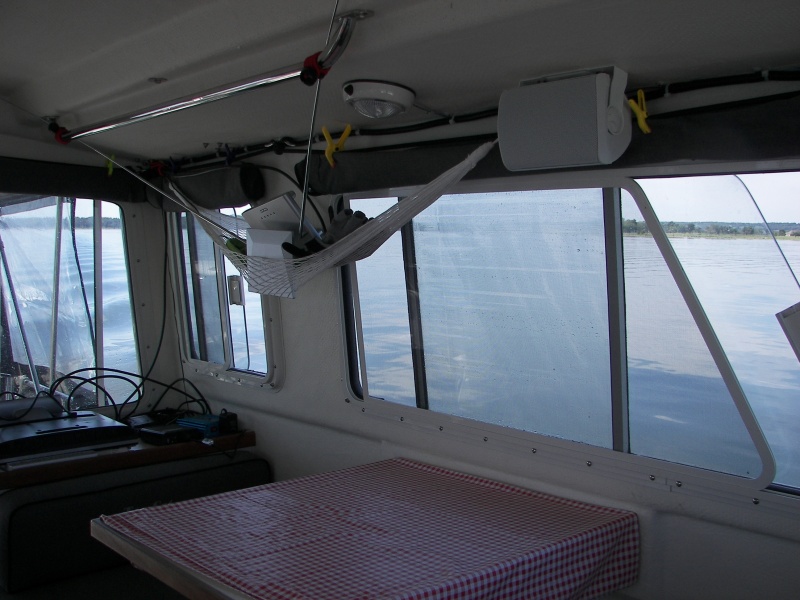 Polaroid flat TV down on the cabinet and the inside antenna looking strange in the hammock. That is because I cannot get TV reception under the metal dock housing unless the antenna is low...  maybe change some day. But, the 'curtains' look good!