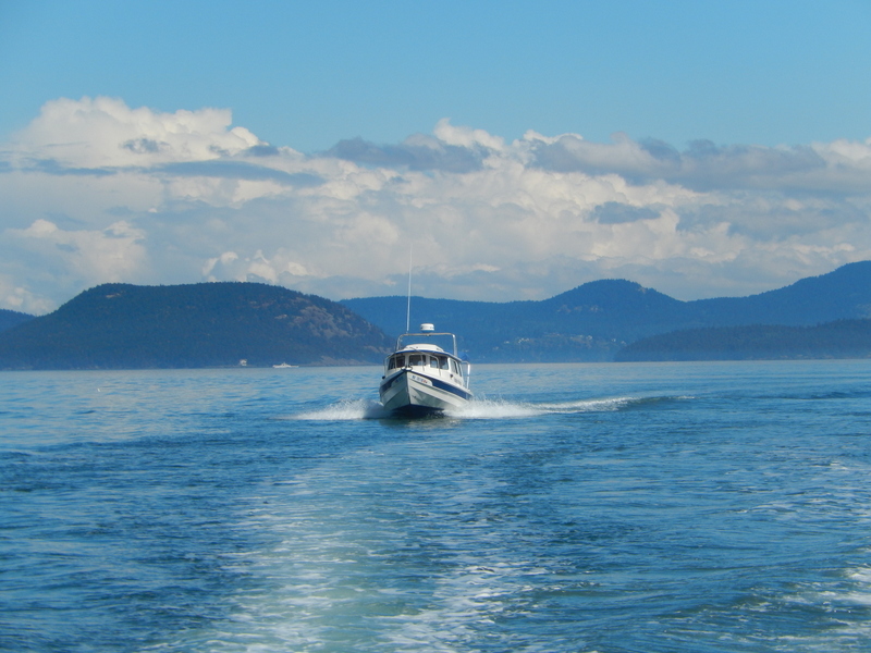 Robbie's Refuge crossing Rosario Strait 
in See-Saw's wake, 
going to Friday Harbor for the gathering
