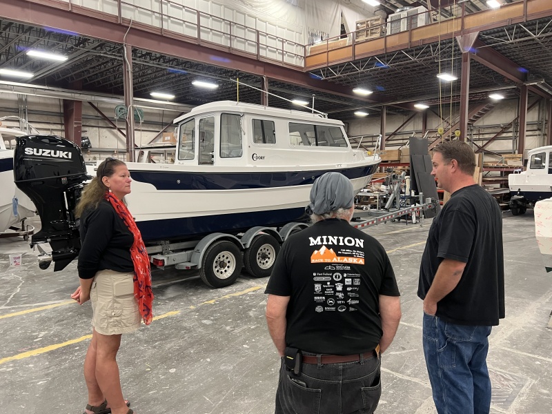 Rosanne and Harvey listening to Michael talk about boat building