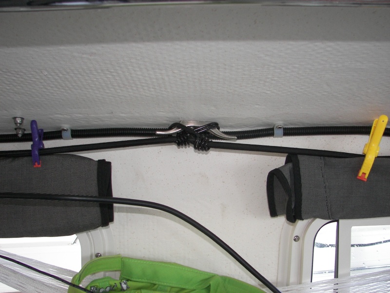 Shock cords on small cleats over windows allow you to hang things, tie up the forward fenders and clip the window covers in varying positions to fit the conditions.