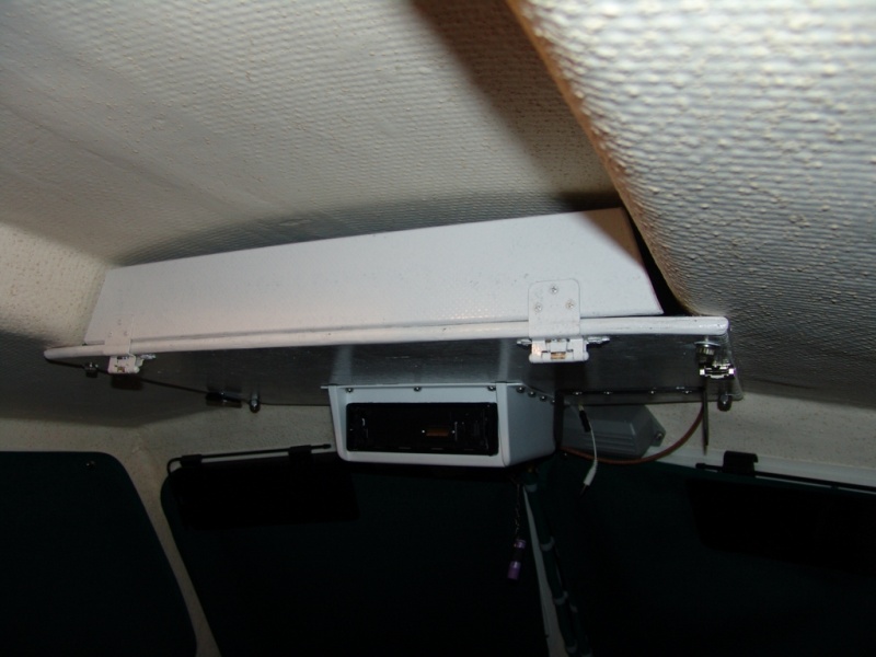 Simple overhead shelf made of plywood.