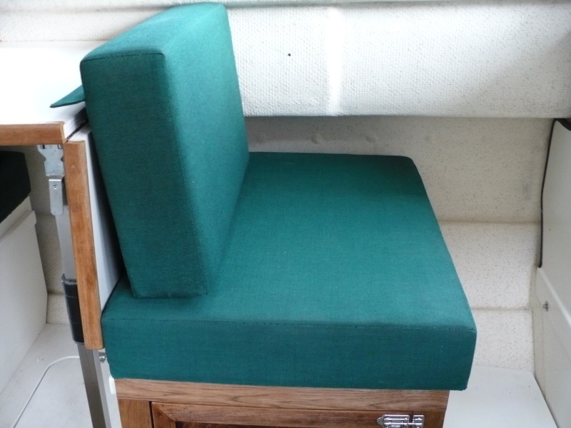 Sliding seat in new position. 

A lumbar pillow is nice to use here. We often sit on a PFD cushion for a better look-out/view. Not pictured here, I added a snap under the table and a small strap snaps into it and then snaps onto the existing cushion snap. This hold the back-rest cushion in place.