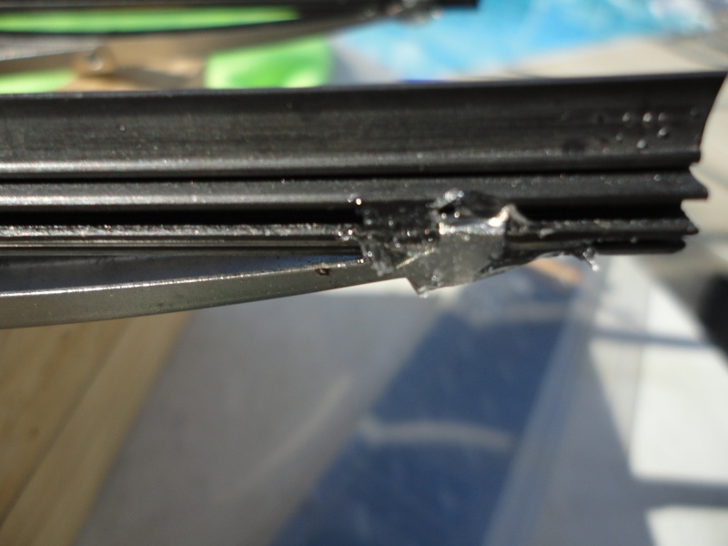 Small amount of "GooP" on one end clip to secure the rubber in the wiper brackets.
