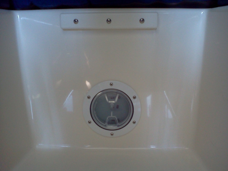 Small clear inspection port added to footwell wall in berth for view of water tank level