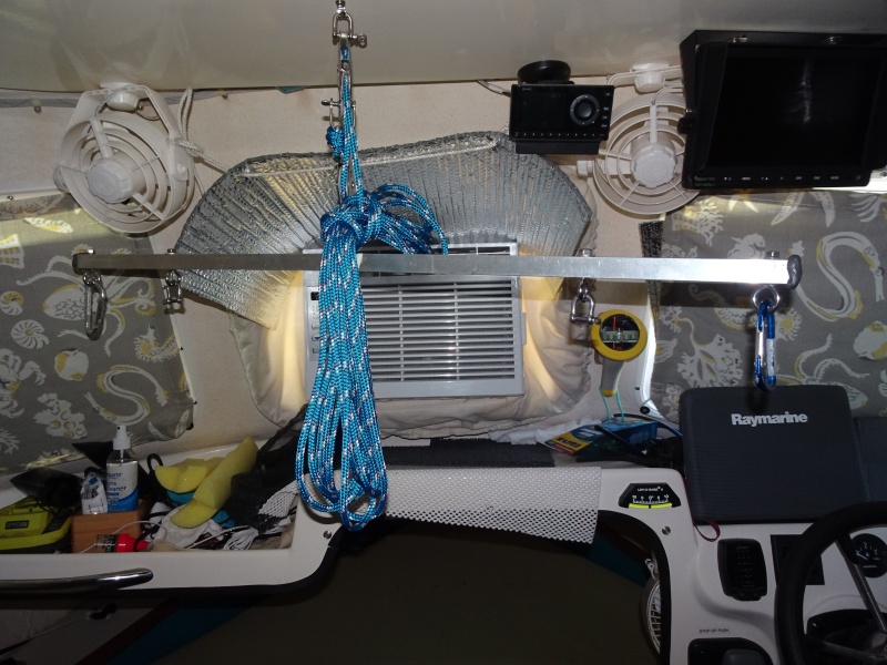 spreader bar in position to. hoist air conditioner.  The outer carabiners are used for hoisting the dinghy, the inner D shackles go over the handles of the window AC unit.  The shelf above has two pieces of 1 1/2" aluminum angle to take the load of the 6 part block and tackle.The shelf was re-enforced with aluminum "L" bracket.