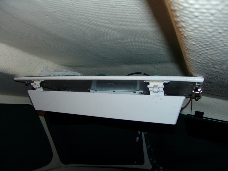 Spring loaded hinge to keep stuff up there.
