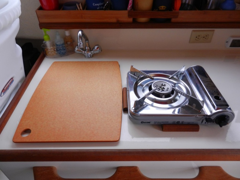 Stove on counter - fits into cleats to hold in place.  Cutting board cleats fit down in sink opening and stays put.  Adds counter space.