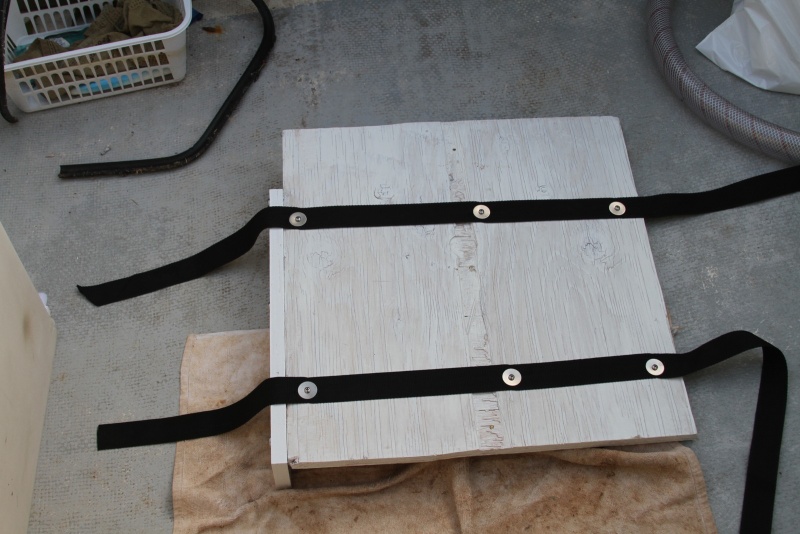 Straps secured to bottom of base.
