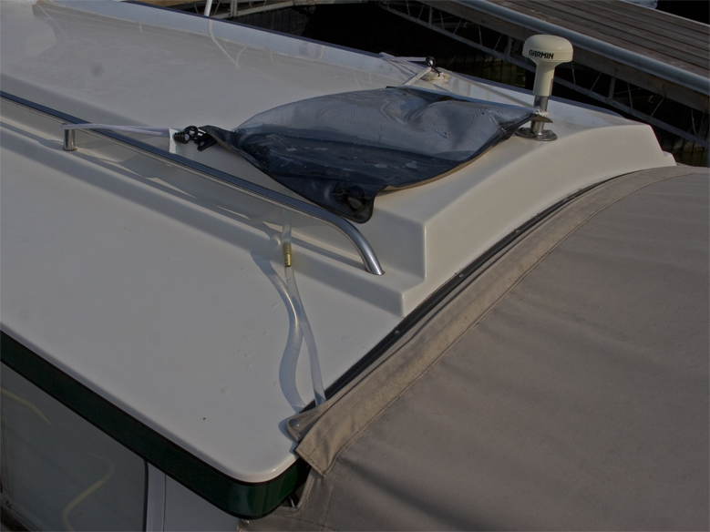 sunshower positioned with hose into cockpit for warm water shower.