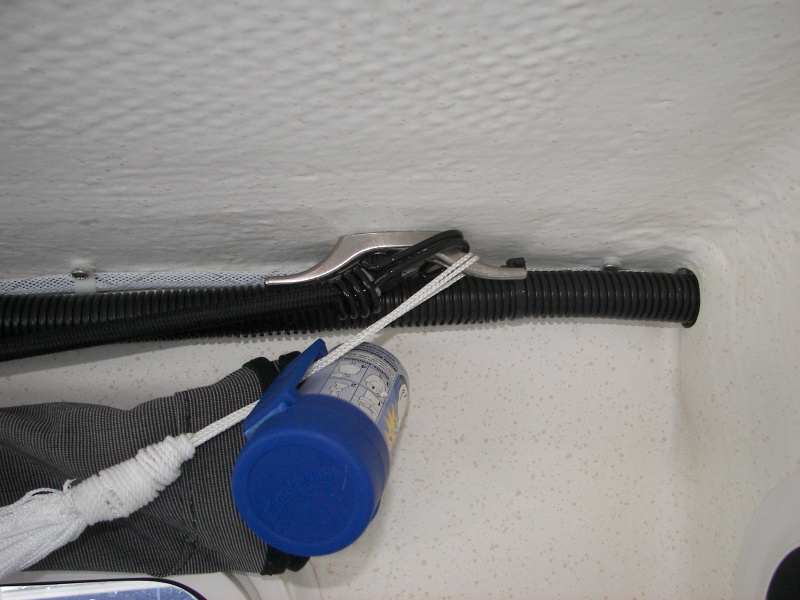 That's a plastic bag dispenser and a mesh gear hammock hanging off that cleat. Remember you must use SHORT SCREWS in this area to avoid damaging the exterior gelcoat!