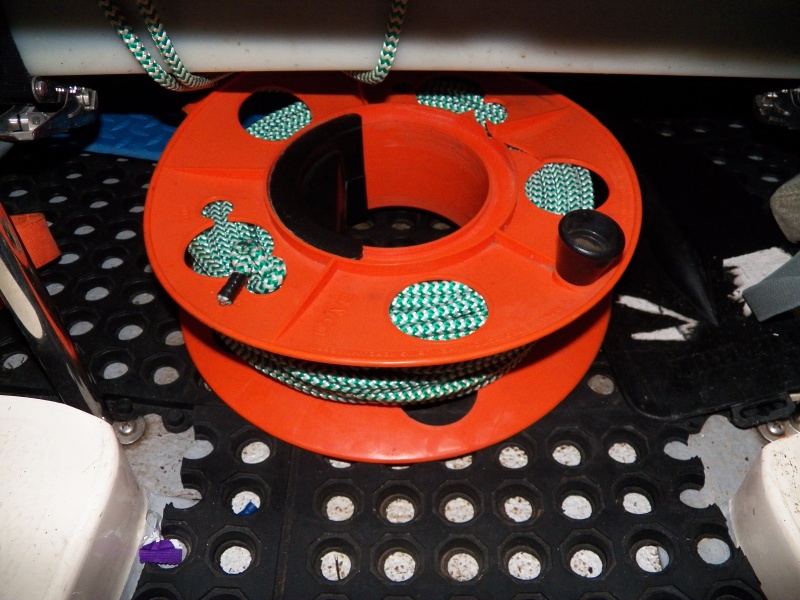 The anchor line is kept on a spool intended for electrical cord.  This is about 140 feet (15-20 pounds?) and still tucks out of the way under the gas tank in the V-berth.  Doing a density/buoyancy calculation, it's about the same as having 35' of 1/4" chain on a 140' rode.