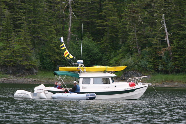 The Commodore's boat, Bidarka with signal flags flying
