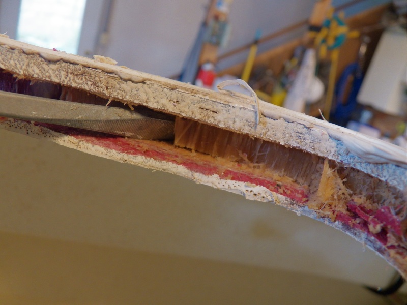 The deck hatch was removed to find saturated balsa core.  It is so wet that the wood has a waxy translucent look, kind of like rotten celery.  There was a bead of caulking around the inside and the outside of the hatch.  The outside caulking had failed (or the screws) and the inside caulking had kept the secret.