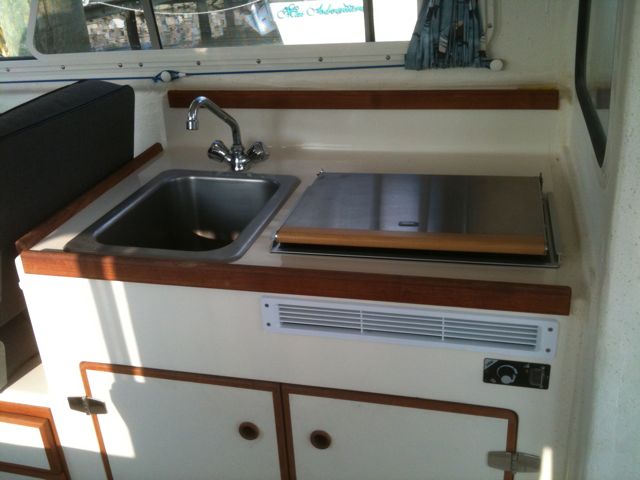 The galley area, showing sink and Wallas heater/stove