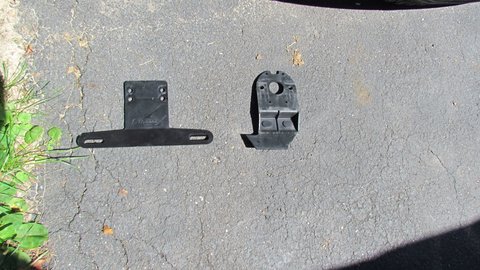 the standard plastic license plate holder failed unit on right $1.99 replacement from Defender on left