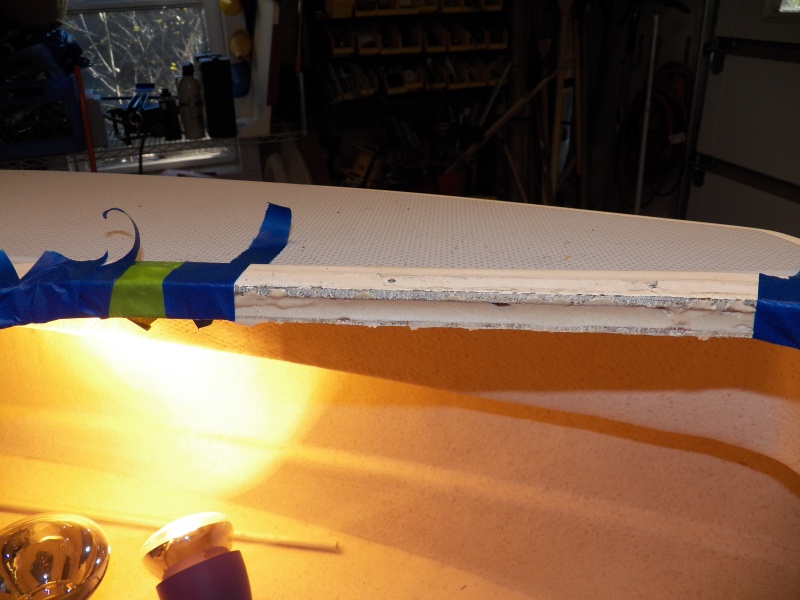 The tape is being removed to show the hardened putty.  The putty goes in over 1 inch, allowing the mounting screws for the hatch to now go into the epoxy rather than the balsa core.  The heat lamps are still being used on the little side deck where the pulpit and cleats have allowed water in.  I had to drill additional holes from underneath to let the moisture out and monitor the drying process.