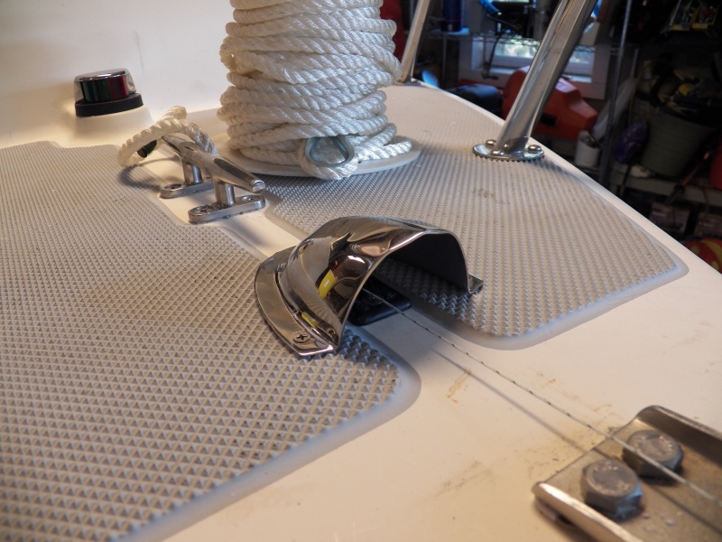 The through-deck block gets a clam shell vent cover to keep rain out.  In the background is the anchor rode that I was going to use, ready to be sent through the blocks using the string.  I changed to using sinking "crab pot" line.  That wasn't as heavy as I wanted, so I'm now using the sinking lead line that is used on the bottom of a gill net.