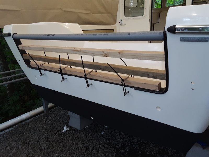 the transom molding was coming loose.  reattached it with 3m 5200 and held it in place like so (days for full cure)