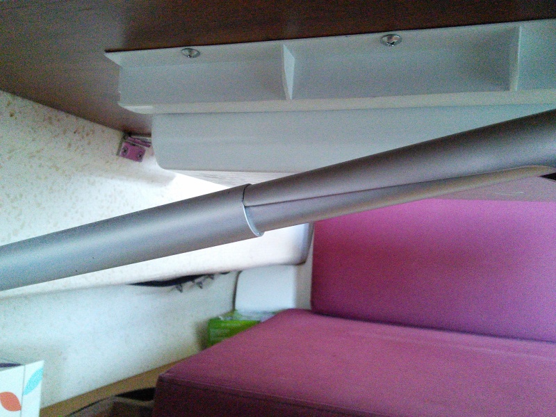 The upper side of this bracket pops up and this allows the table to fold down against the hull.  The bracket holds tight is all conditions we have encountered despite the flimsy appearance.
