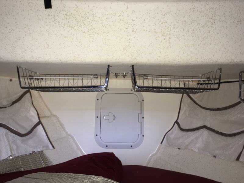 These 2 stainless racks are smaller but will be used for the same purpose as the others.  These split the anchor well door.  They do not impair access to the well and the door still fully opens.