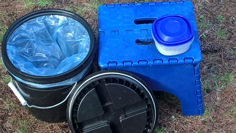 This a 2 gallon bucket with a water-tight "gamma" lid.  A double layer plastic bag goes under the lip and the lid screws down.  The folding stool is used to get in and out of the boat, but also brings the height of the toilet to a comfy position.