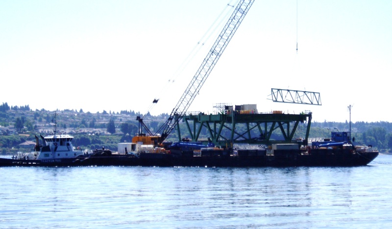 This deck section is 116 feet long, and weighs over 450 tons. The mast on the front of the barge is the GPS antenna.