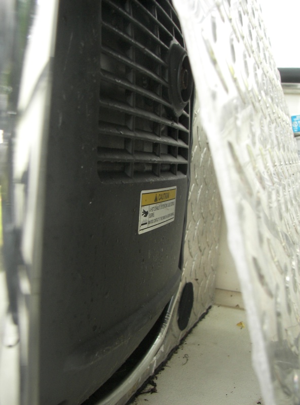 This is the most extreme cut-out you'd need and I still had very little seawater intrusion.  I had to allow for the genset to slide this way for the 30 amp yoke to clear the restricted lid opening.