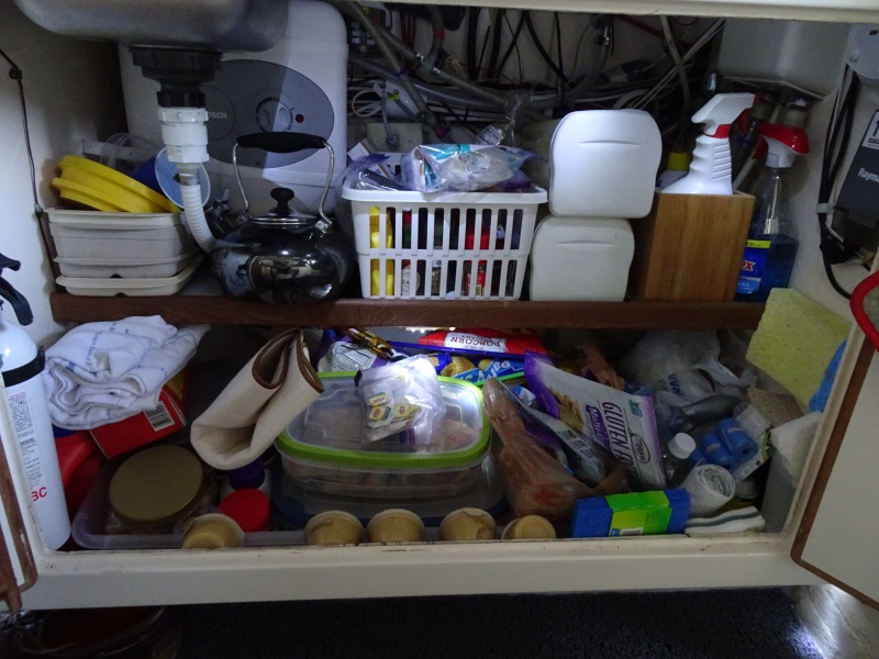 This shows the under the galley storage area, and in this case it is lit by LED lights which are on under the shelf, and from the top.  Note the water heater behind the galley sink.  Fire extinguisher to the left.