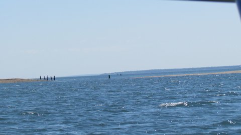 tight exit / entrance to Coecles Harbor see sand bar stretching out from the starboard side. Surf fisherman on the port side