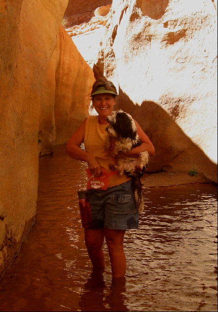 Toni Carrying Baxter in Stream Bed through Slot at Fifty Mile Canyon 9-22-09