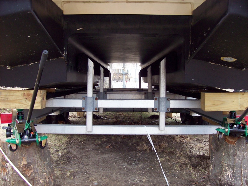 Tree stumps cut level, 3 ton jacks, steel plate, and 6X6 beams.  Worked like a champ.