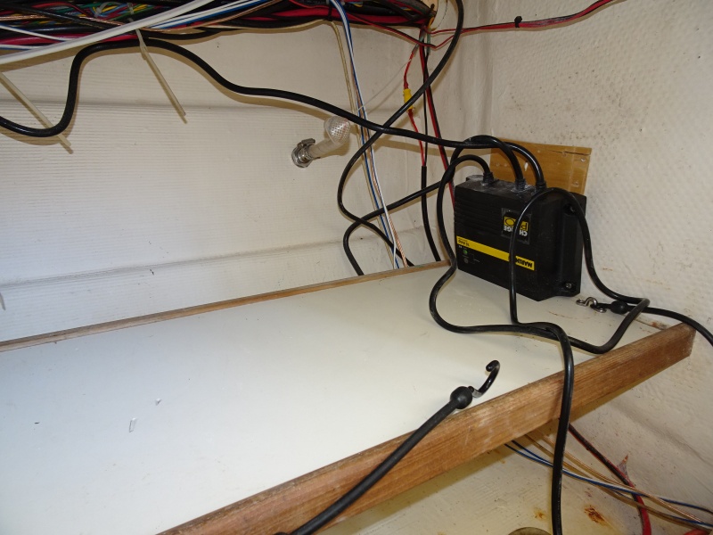 Under galley storage shelf and battery charger