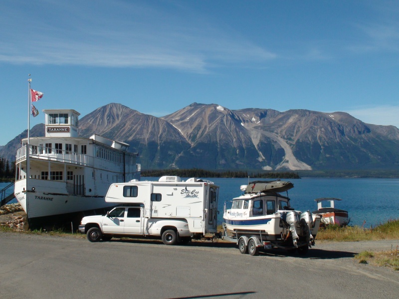 Us parked by old lake boat in town of Atlin.