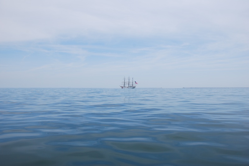 USCG Cutter EAGEL viewed at abt 1215, 06-11-2012 west of the 3rd & 4th Island to the CBBT heading north to Baltimore, MD after it departed from Norfolk's OPSAIL 2012 in Norfolk,VA.
The CBBT bridge span leading to the second tunnel can be seen in the haze aft of the EAGEL, on the horizon.