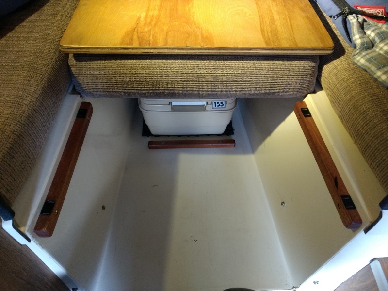 Used up some of the left over mahogany and birch ply from the fridge shelf project to fill in the opening at the front of the v-berth.

Velcro tabs used to keep it in place and to keep it from rattling.