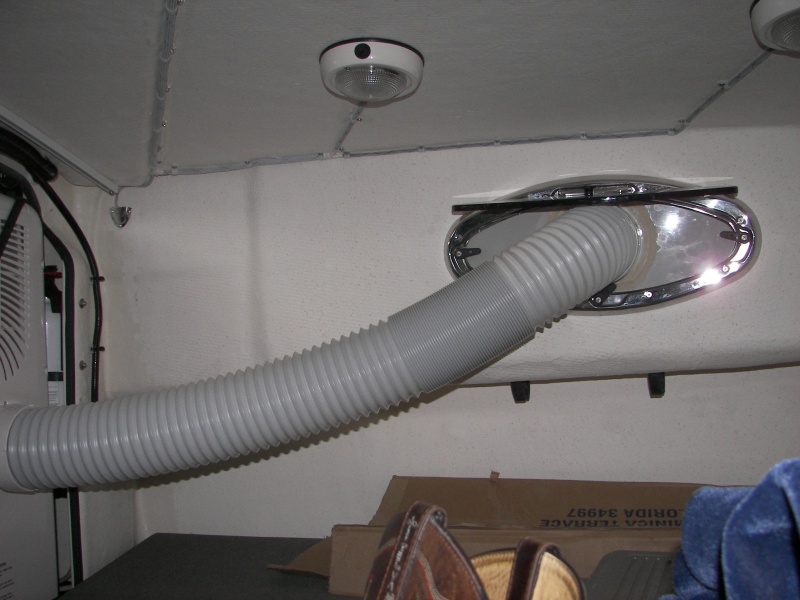 Using screen as template, cut and fit outlet fitting to clip into screen flanges of TomCat windows. 'Had to offset hole upward to leave room for bottom clip. Plastic strips (3) came with A/C.