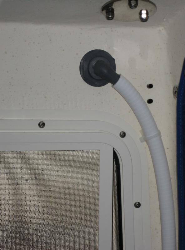 Vent through hull for potti has a chrome "look" exterior tucked up under the roof overhang.