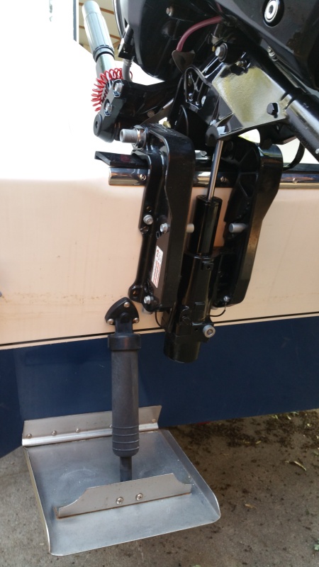 View of kicker motor bracket in relation to trim tab hardware