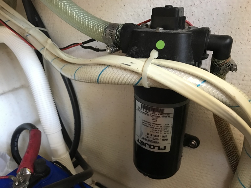 Washdown pump in galley counter cabinet.