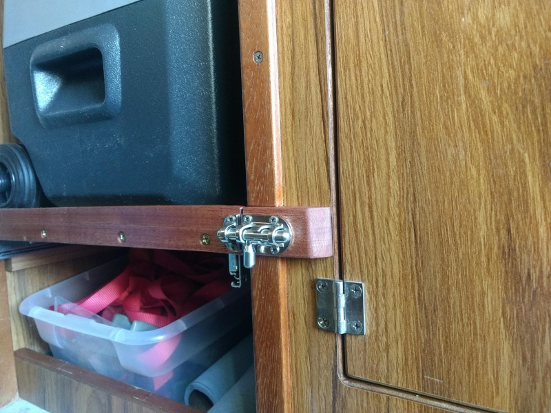 While I doubt the fridge shelf would slide out on it's own I added this spiffy little slide bolt latch to secure it while underway, "just in case".