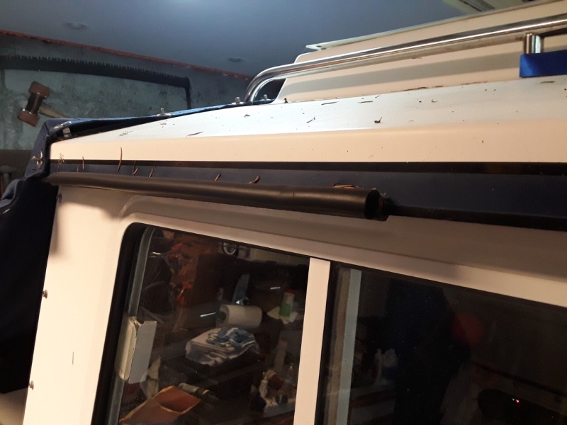Widow "gutter" made from press-on gasket material used for sealing hatches.  It is available in 180 and 90 degree (this is 90 degree used to form a gutter to keep rain from dripping in the captain's window.  I used the 180 degree for "head protection" above the cabin entrance.