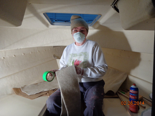 Working on installing the hull liner in the V-berth.
