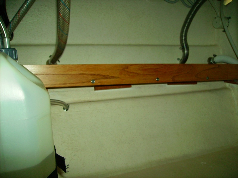 You can see wood glued to hull with 5200 quick set.  Then "L" brackets installed to hold shelf.  Very secure.